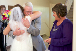 John hugs Alissa after seeing her in her wedding dress. Wedding pictures by Tiffany & Steve of Warmowski Photography. 