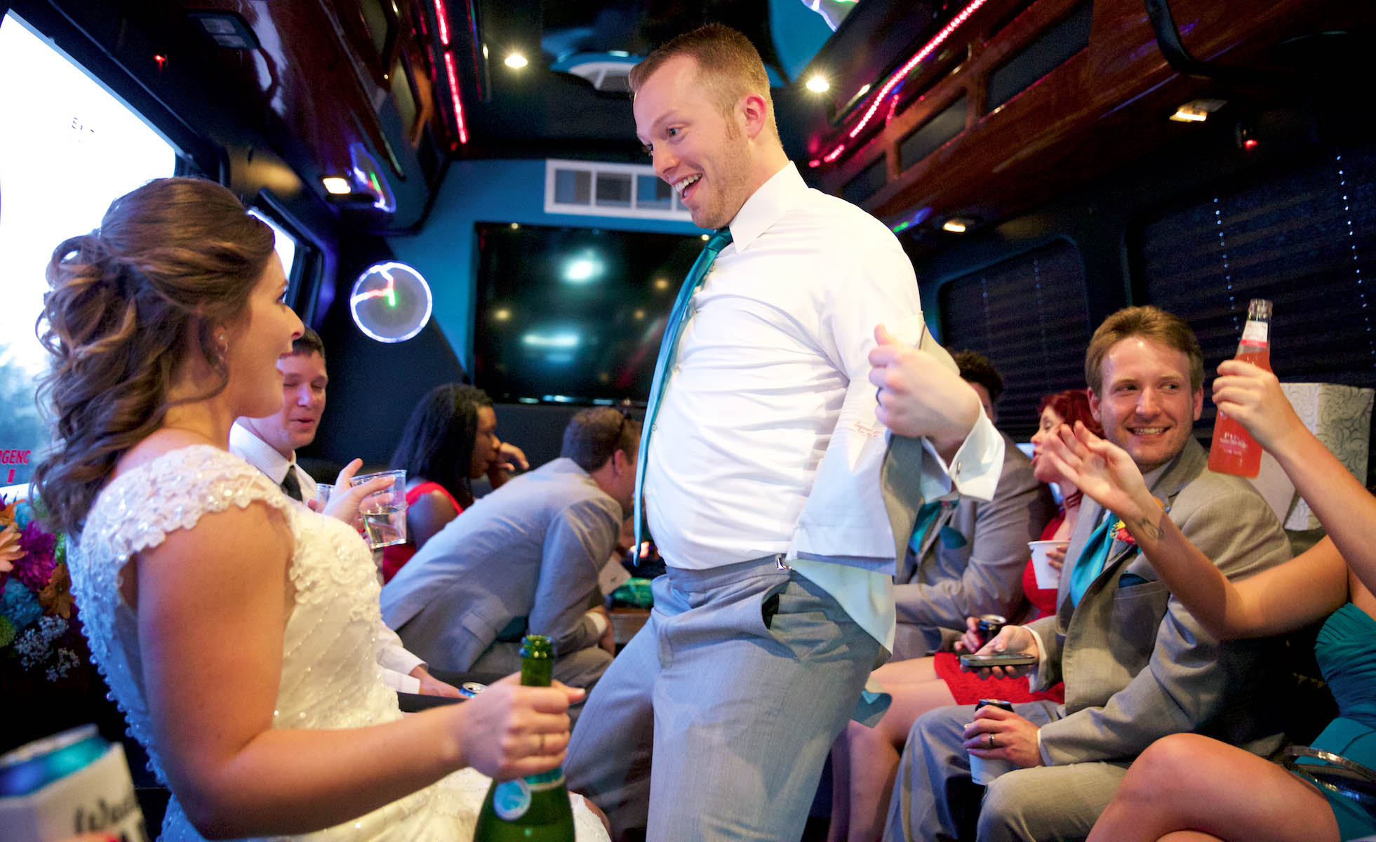 Ben has fun with Alissa on the party bus. Wedding pictures by Tiffany & Steve of Warmowski Photography.