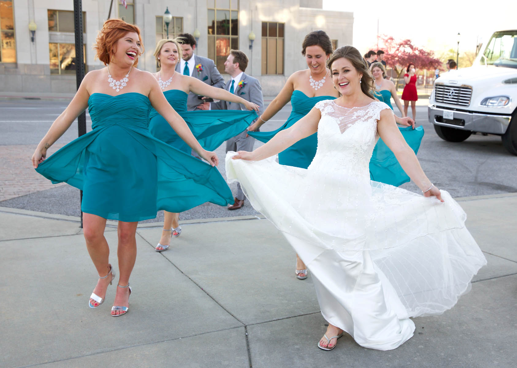 Alissa and her bridesmaids have fun with their flowy dresses. Wedding pictures by Tiffany & Steve of Warmowski Photography.