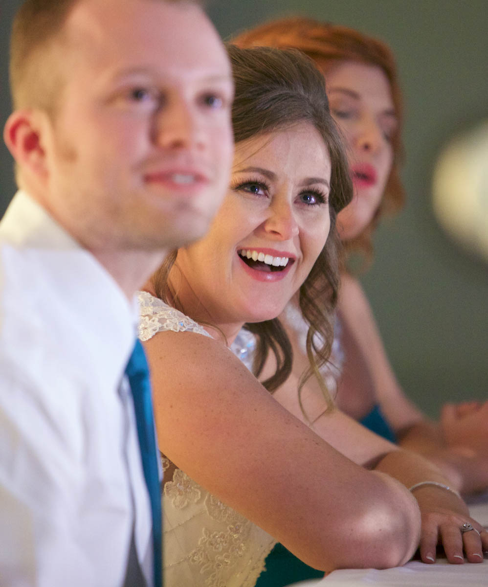 Ben and Alissa react to the best man's toast. Wedding pictures by Tiffany & Steve of Warmowski Photography.