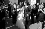 Alissa & Brandon walk through bubbles, after the ceremony at Our Saviour Catholic Church, Jacksonville. Wedding photography by Tiffany & Steve Warmowski.