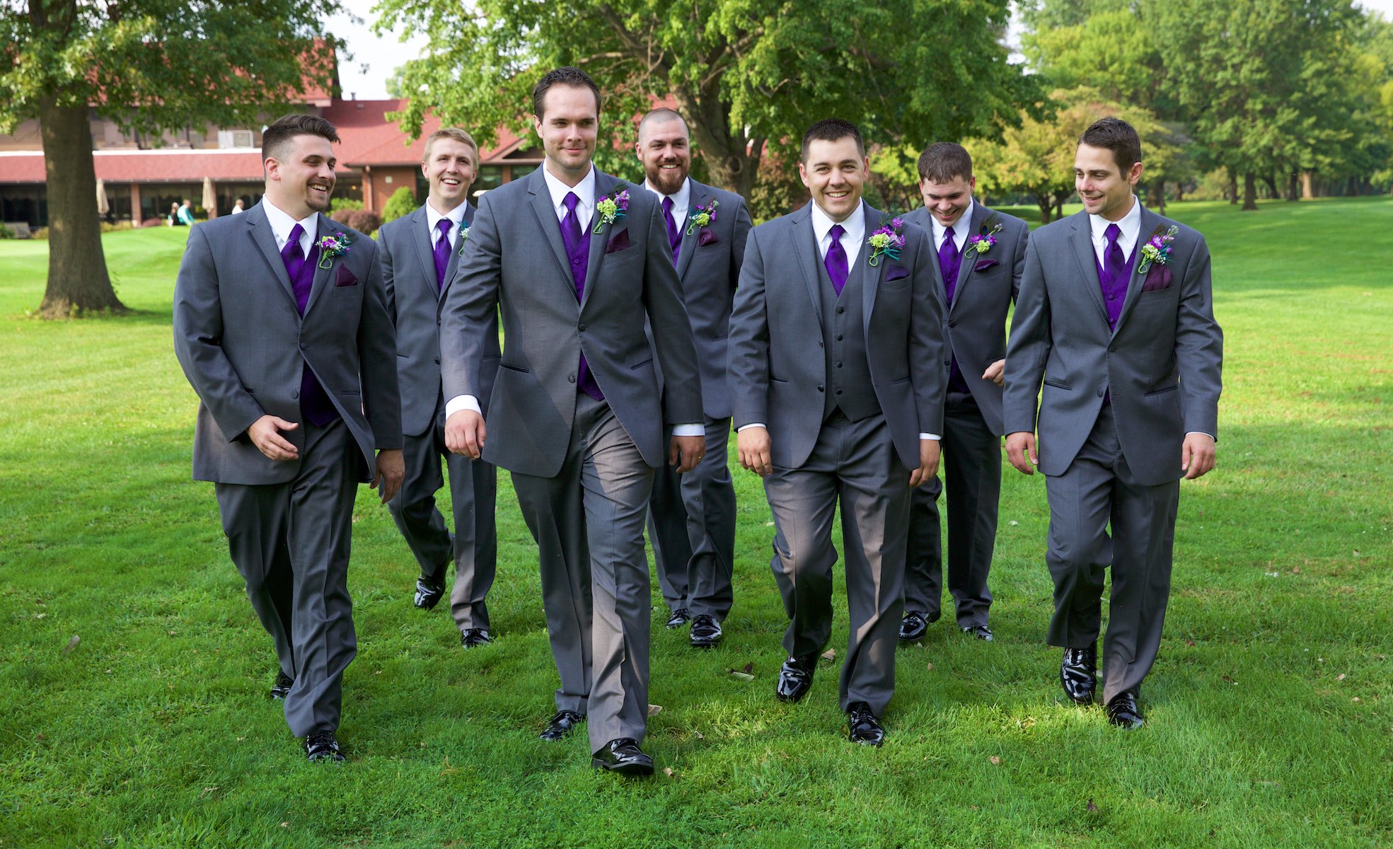Nick walks with his groomsmen and ushers to the outdoor wedding ceremony site at the Jacksonville Country Club. Sometimes when the groomsmen want to do a cool group photo we have them walk Reservoir Dogs-esque, but this crew did this all naturally. Wedding photography by Steve & Tiffany Warmowski.