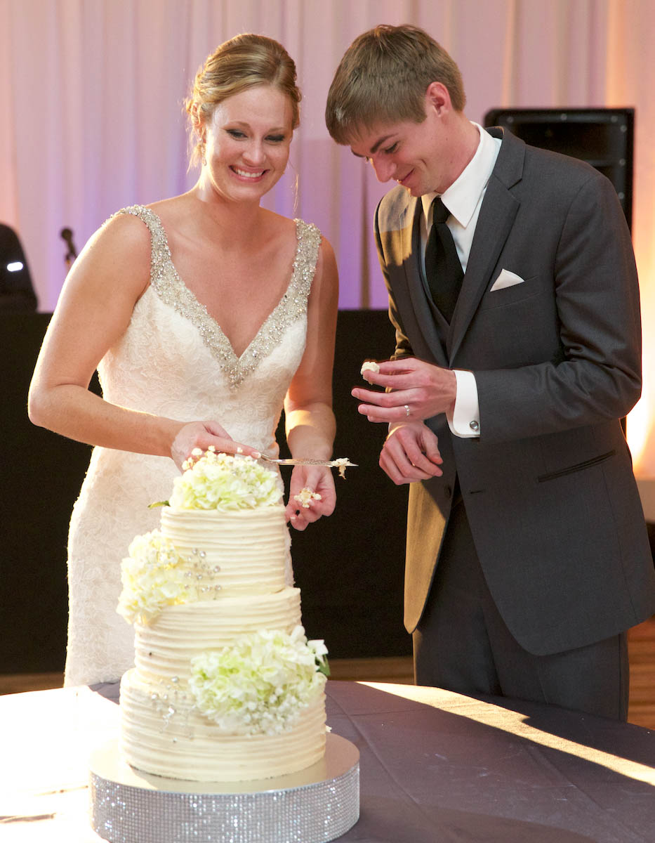 Jaclyn & Scott cut the cake, wedding reception at iHotel, Champaign. Wedding photography by Tiffany & Steve of Warmowski Photography.