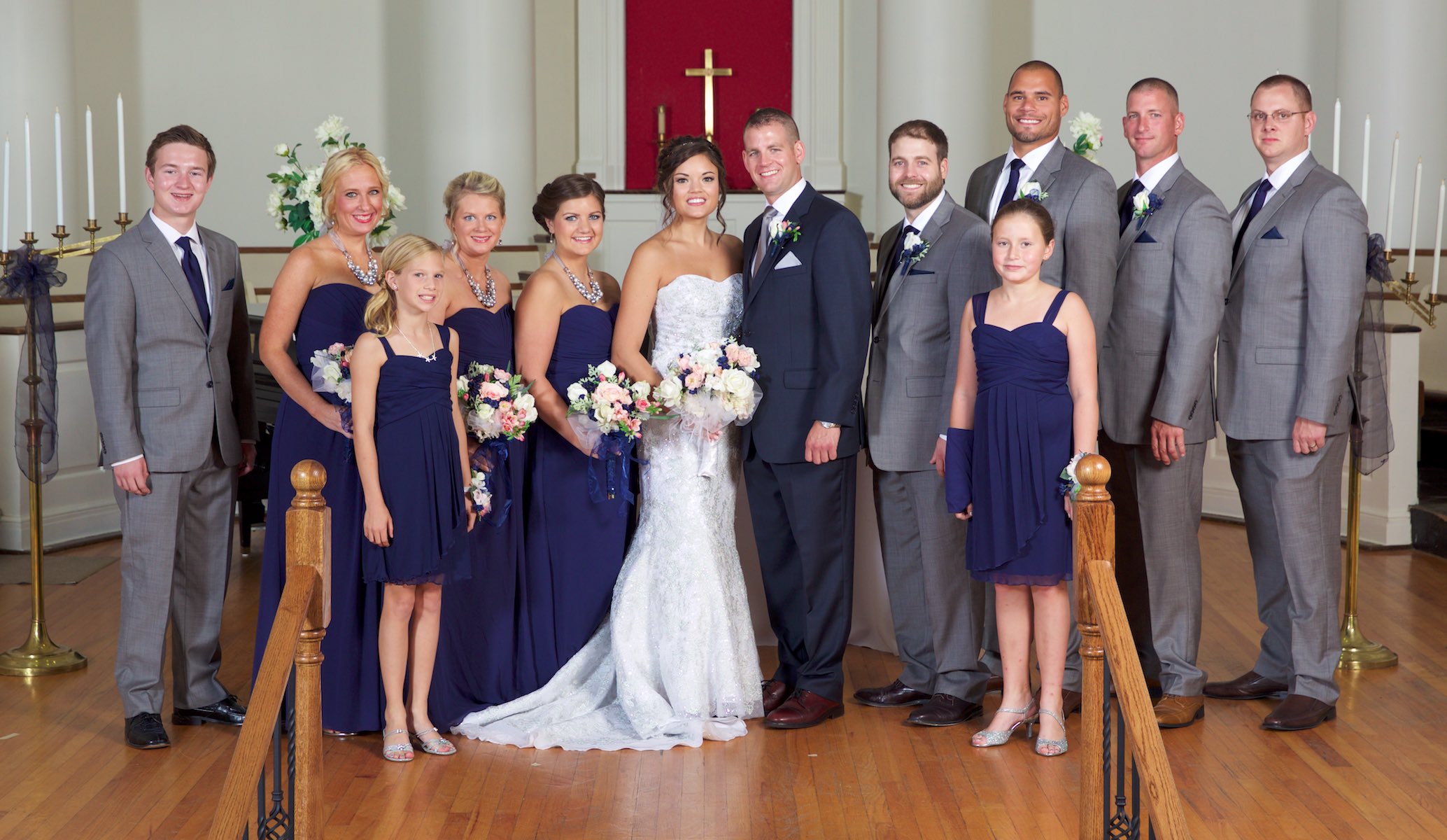 Jeremy and Adria with bridal party, portraits around MacMurray College's Annie Merner Chapel before the ceremony, Jacksonville, Illinois. Wedding photography by Steve & Tiffany Warmowski.