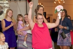 Catching the bouquet, bouquet toss, wedding reception at Hamilton's 110 North East, Jacksonville, Illinois. Wedding photography by Steve & Tiffany Warmowski.