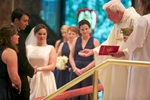 Blessing the rings, Elizabeth & Daniel's wedding ceremony at St. Rita of Cascia Shrine Chapel in Chicago. Wedding photography by Steve & Tiffany Warmowski