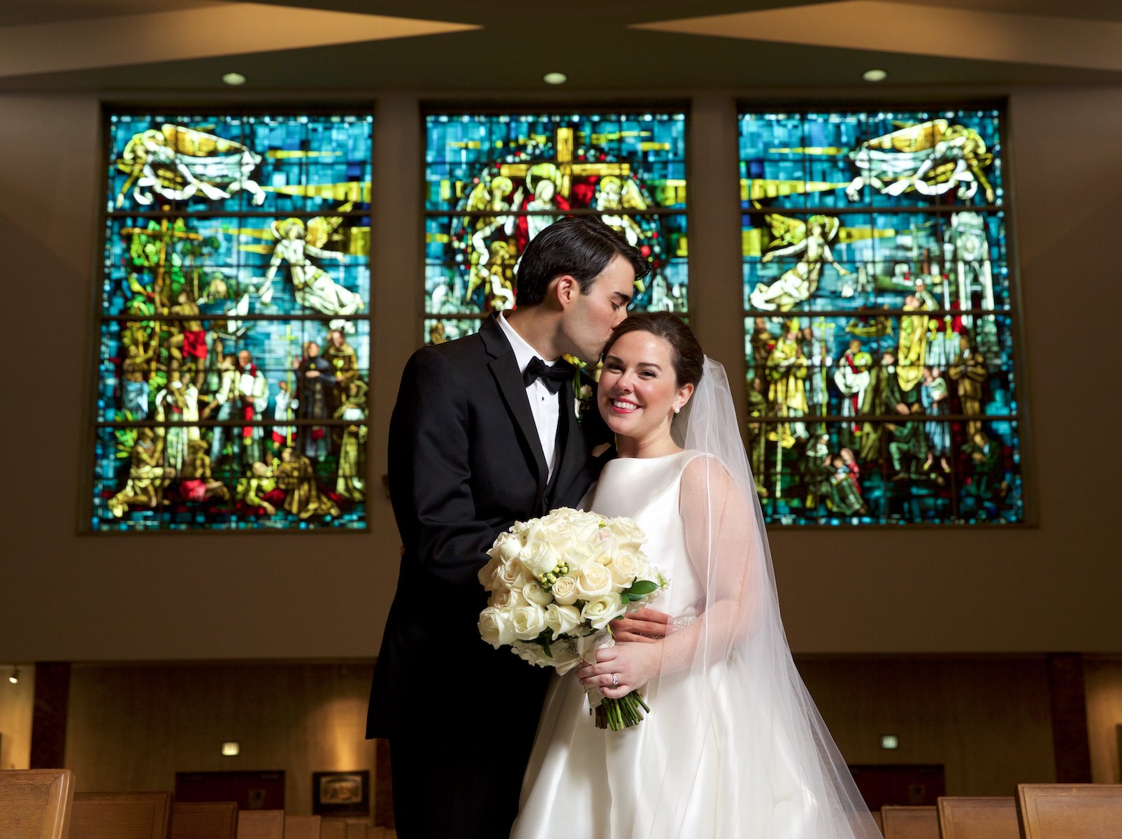 Elizabeth & Daniel wedding portraits, featuring the stained glass windows at St. Rita of Cascia Shrine Chapel in Chicago. Wedding photography by Steve & Tiffany Warmowski