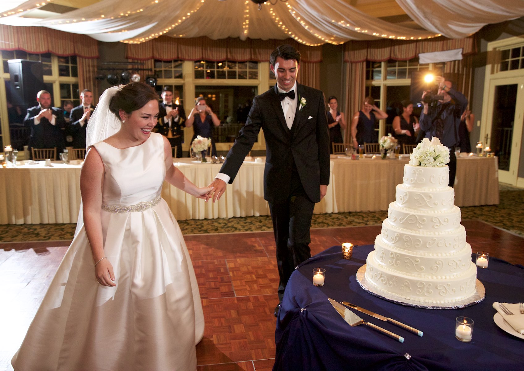 Elizabeth & Daniel move to cut wedding cake, wedding reception at Crystal Tree Country Club, Orland Park. Wedding photography by Steve & Tiffany Warmowski