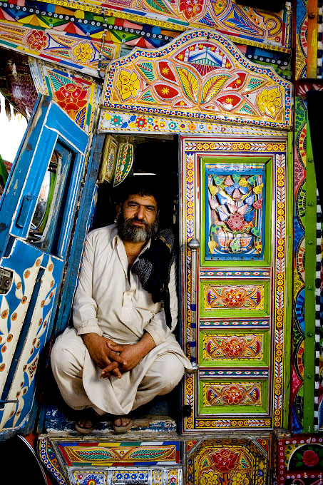 Truck drivers and the young men working with and around them. All of these portraits were taken in the truck lots surrounding the vegetable market in Rawalpindi Pakistan on March 23rd 2008.Nazir, truck driver, 48 years old, driving for 30 years.
