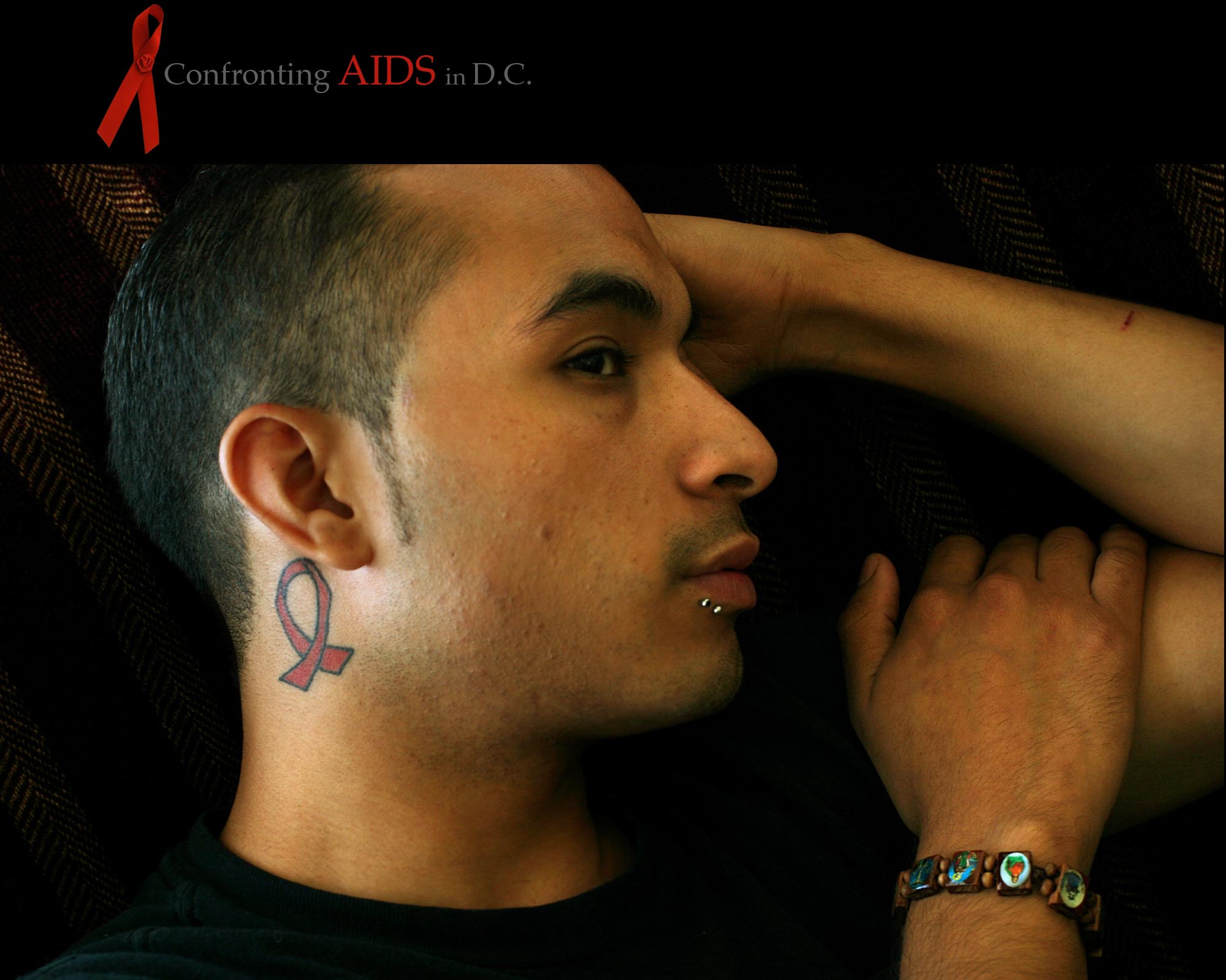 where about 1 in 20 residents is infectedA RED RIBBON ­ symbol of the fight against AIDS ­ is tattooed on José Ramirez's neck and posted prominently on the bulletin board in his office. {quote}It's me; it's who I am,{quote} says Ramirez, 26, coordinator of the Youth Mpowerment programs at D.C.'s Clinica del Pueblo. {quote}It opens up conversations.{quote}Ramirez, who educates young gay and bisexual Latino men about AIDS prevention, is working to slow the increase in cases. A recent Kaiser FamilyFoundation survey found that Hispanics in the District have the highest rate of new AIDS cases in the country, about 110 per 100,000 people. {quote}It really does change your life,{quote} says Ramirez who learned of his HIV-positive status as a 17-year-old high school student in Durham, N.C. {quote}I haven't cried about it, yet. I want to be strong about it. I think that's what helps me.{quote}ALL RIGHTS RESERVED ©2008 Nikki Kahn