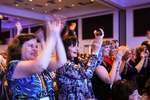 Attendees applaud APIC President Patti Grant during the opening session.