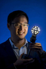 Gimmy Chu, co founder and chief executive officer at Nanoleaf Ltd., holds a Nanoleaf Ltd., lightbulb as he stands for a photograph after an interview in San Francisco, California, U.S., on Tuesday, Aug. 5, 2014. Nanoleaf Ltd. has developed the first LED light bulb that can change colors, save up to 88% of electricity and last 20 times longer compared to incandescent bulbs. Photograph by David Paul Morris