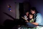 Lois Bukowski (R) and Katie Baer read to their son Wade Baer-Bukowski, 3 before he goes to bed at home in Oakland, California.