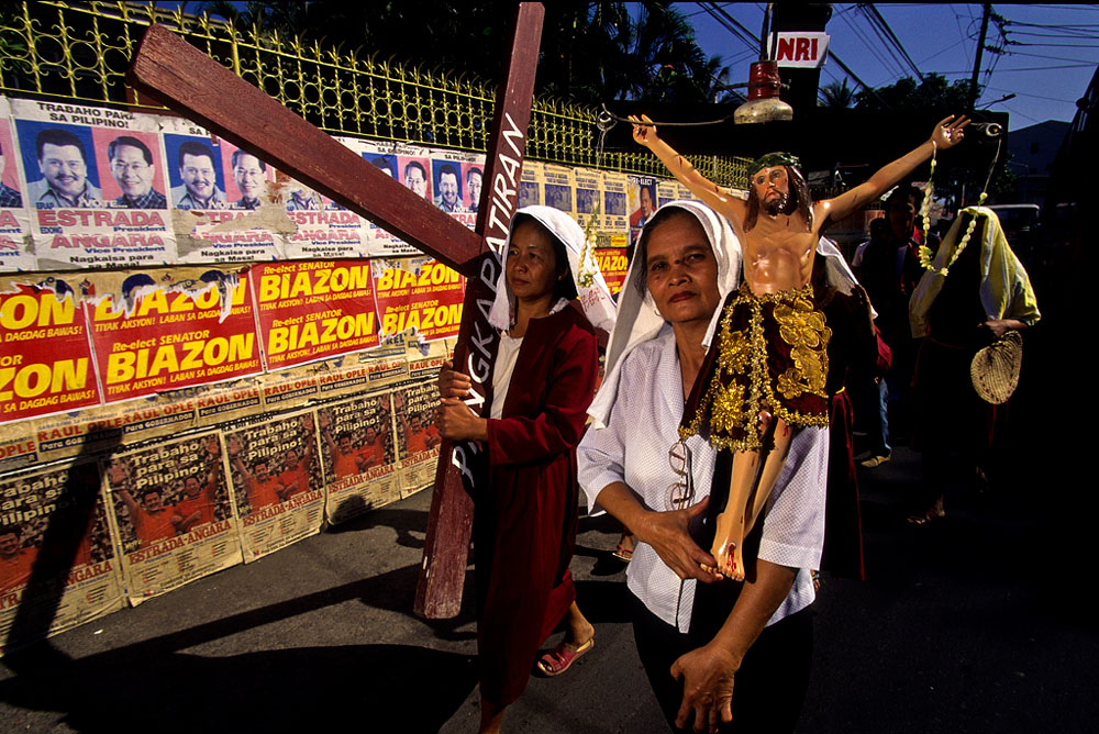 People take part in a Catholic march during Easter week in Manila, Philippines.