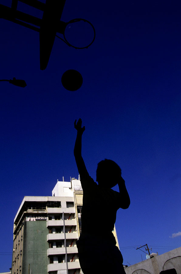 A young boy plays basketball in a park in Manila, Philippines.