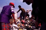 Workers climb over mountains of trash as they look for recyclable goods.