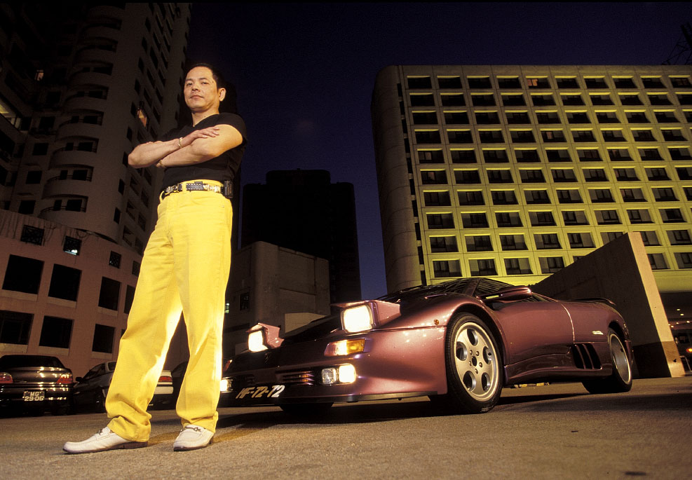 Mob boss Wan Kuok Koi stands in front of his Ferrari on the streets of Macau, China.