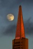The full moon rises over the TransAmerica building in San Francisco.