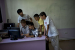 June 04, 2013: KARAKERT, ARMENIA- Children gather around a computer at a COAF-funded school in the village of Karakert.  COAF, The Children of Armenia Fund, was founded by Istanbul-born, American-based Armenian Dr. Garo Armen, who was struck by the depths of poverty in the Aramir region of Armenia and resolved to do something about it.  The organization, which is largely supported by Diasporan Armenians, mostly funds schools, but also assists in providing a more comprehensive social care to the families of the village children. Photo by Scout Tufankjian/Polaris