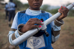 May 5, 2018: KANENGUERERE, ANGOLA - HALO deminer Teresa Wandi Cesar checks her equipment before starting the day.  These deminers are working under extremely difficult circumstances in Kanenguerere.  Not only is extremely hot - with snakes and scorpions common - but much of the mined area is on the side of an extremely steep hill, making every step dangerous. The area was mined during the civil war by government forces to protect the nearby railway line that can be seen in the background, as well as various troop positions. It is currently used by roughly 170 people including village residents and nomadic herders - many of whom are young children - who pass through uncleared land every day. 