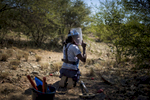 May 3, 2018: KANENGUERERE, ANGOLA - HALO deminer Avelina Cassingue checks her lane for anti-personnel mines in Kanenguerere.  The area was mined during the civil war by government forces to protect the nearby railway line, as well as various troop positions. 