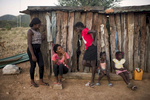 May 6, 2018: KANENGUERERE, ANGOLA - HALO deminers Imaculada Celestino and Suzana Soares visit with some of the children of Kaneguerere village - fourteen year-old Aurora, Suzy and Wandi on Sunday afternoon. The family moved into the village recently so that the children could go to school, and they have a small plot of land by the river where they grow a few vegetables.  The girls, especially, love the HALO deminers and want them to stay in the village forever. The HALO team has Sundays off, so the day is spent going to church, relaxing, and getting caught up on work.  These deminers are working under extremely difficult circumstances in Kanenguerere.  Not only is extremely hot - with snakes and scorpions common - but much of the mined area is on the side of an extremely steep hill, making every step dangerous. The area was mined during the civil war by government forces to protect the nearby railway line that can be seen in the background, as well as various troop positions. It is currently used by roughly 170 people including village residents and nomadic herders - many of whom are young children - who pass through uncleared land every day. 