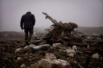 An employee of the international mine clearance organization, the HALO Trust, walks through the fog past a destroyed anti-aircraft gun on November 30, 2020, during a visit to the site of a massive military ammunition depot in Aygestan, Nagorno-Karabakh that was destroyed in an Azerbaijani strike early on in the war, scattering unexploded ordnance from rockets to bullets and warheads to fuses across nearby villages.  