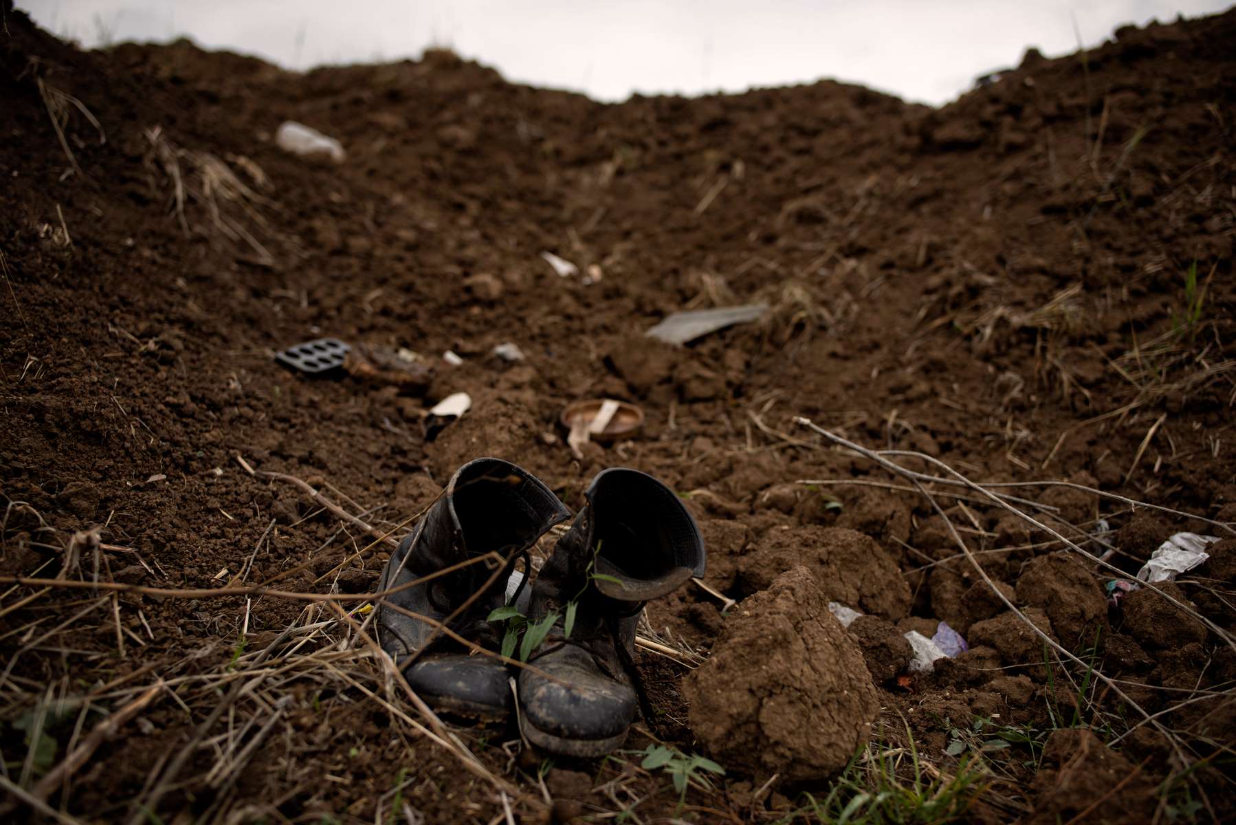 A soldier’s boots stand side by side in an abandoned trench in Martuni region.  While final numbers have not yet been settled, as bodies have not yet been identified nor have numbers of prisoners of war been confirmed, conservative estimates suggest that over 3000 Armenians were killed out of a total population of 2.5 million. 
