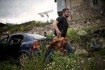 The son of a beneficiary (NAME TK) unloads a carload of chickens in Harav village. NAMES TK