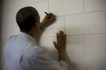 August 8, 2012- GRAND JUNCTION, CO: President Barack Obama signs the wall of Grand Junction High School, as is the school's tradition for distinguished guests, after a rally in Grand Junction, CO on August 8th, 2012. (Scout Tufankjian for Obama for America/Polaris)