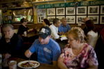 August 15, 2012- CEDAR RAPIDS, IA: Patrons of Riley's Cafe in Cedar Rapids eat as President Barack Obama shares breakfast with three US Military Veterans. (Scout Tufankjian for Obama for America/Polaris)
