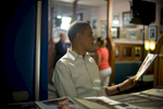 August 15, 2012- DAVENPORT, IA: President Barack Obama looks nostalgic as he signs a copy of a magazine with pictures of his daughters when they were much younger on the cover backstage at Logomarcino’s Ice Cream Shoppe in Davenport, Iowa. (Scout Tufankjian for Obama for America/Polaris)