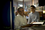 August 15, 2012- DAVENPORT, IA: President Barack Obama laughs as he signs a book backstage at Logomarcino’s Ice Cream Shoppe in Davenport, Iowa. (Scout Tufankjian for Obama for America/Polaris)