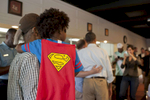 September 3, 2012 - TOLEDO, OH: A young boy in a Superman costume waits to meet President Barack Obama during his visit to Rick's City Diner in Toledo, OH. (Scout Tufankjian for Obama for America/Polaris)