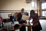 September 5, 2012 - CHARLOTTE, NC: President Barack Obama looks nostalgically at an old picture of himself speaking while he and his wife, First Lady Michelle Obama sign things for supporters during the Democratic National Convention. (Scout Tufankjian for Obama for America/Polaris)