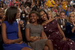 September 6, 2012 - CHARLOTTE, NC: First Lady Michelle Obama bumps heads affectionately with her youngest daughter Sasha as her oldest daughter Malia looks on, during President Barack Obama's speech at the 2012 Democratic National Convention in Charlotte. (Scout Tufankjian for Obama for America/Polaris)
