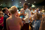 September 8th, 2012 - Orlando, FL: President Barack Obama holds a small baby at Gator's Dockside sports bar in Orlando, FL. (Scout Tufankjian for Obama for America/Polaris)
