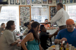 September 8, 2012 - Tampa, FL: President Barack Obama teases a young spikey-haired patron of the West Tampa Sandwich Shop and Restaurant in Tampa, FL. (Scout Tufankjian for Obama for America/Polaris)