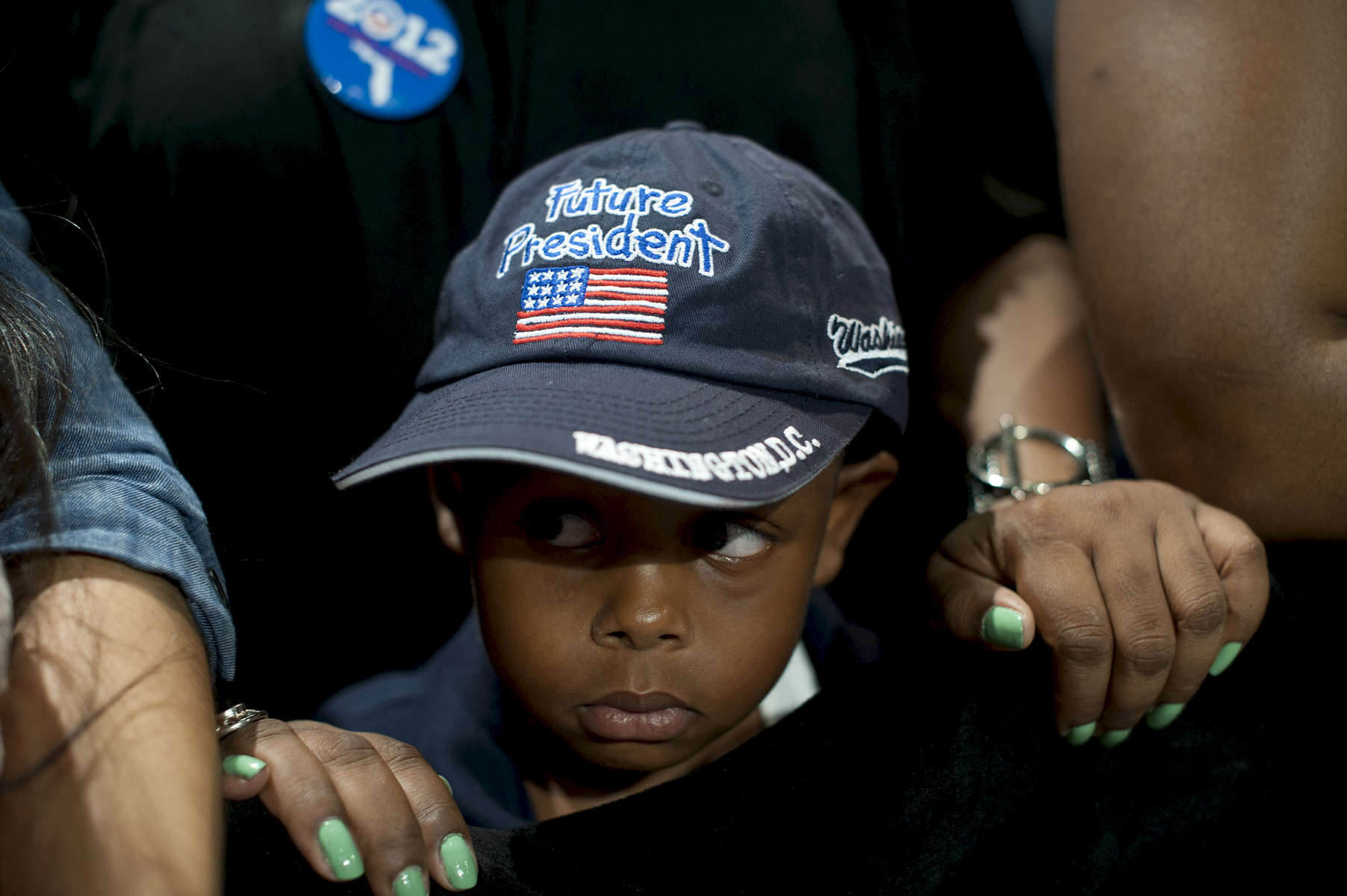 September 9, 2012 - West Palm Beach, FL: A young boy wearing a hat  declaring him a {quote}Future President{quote} listens to current President Barack Obama speak at a campaign event in West Palm Beach, FL. (Scout Tufankjian for Obama for America/Polaris)