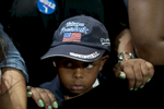 September 9, 2012 - West Palm Beach, FL: A young boy wearing a hat  declaring him a {quote}Future President{quote} listens to current President Barack Obama speak at a campaign event in West Palm Beach, FL. (Scout Tufankjian for Obama for America/Polaris)
