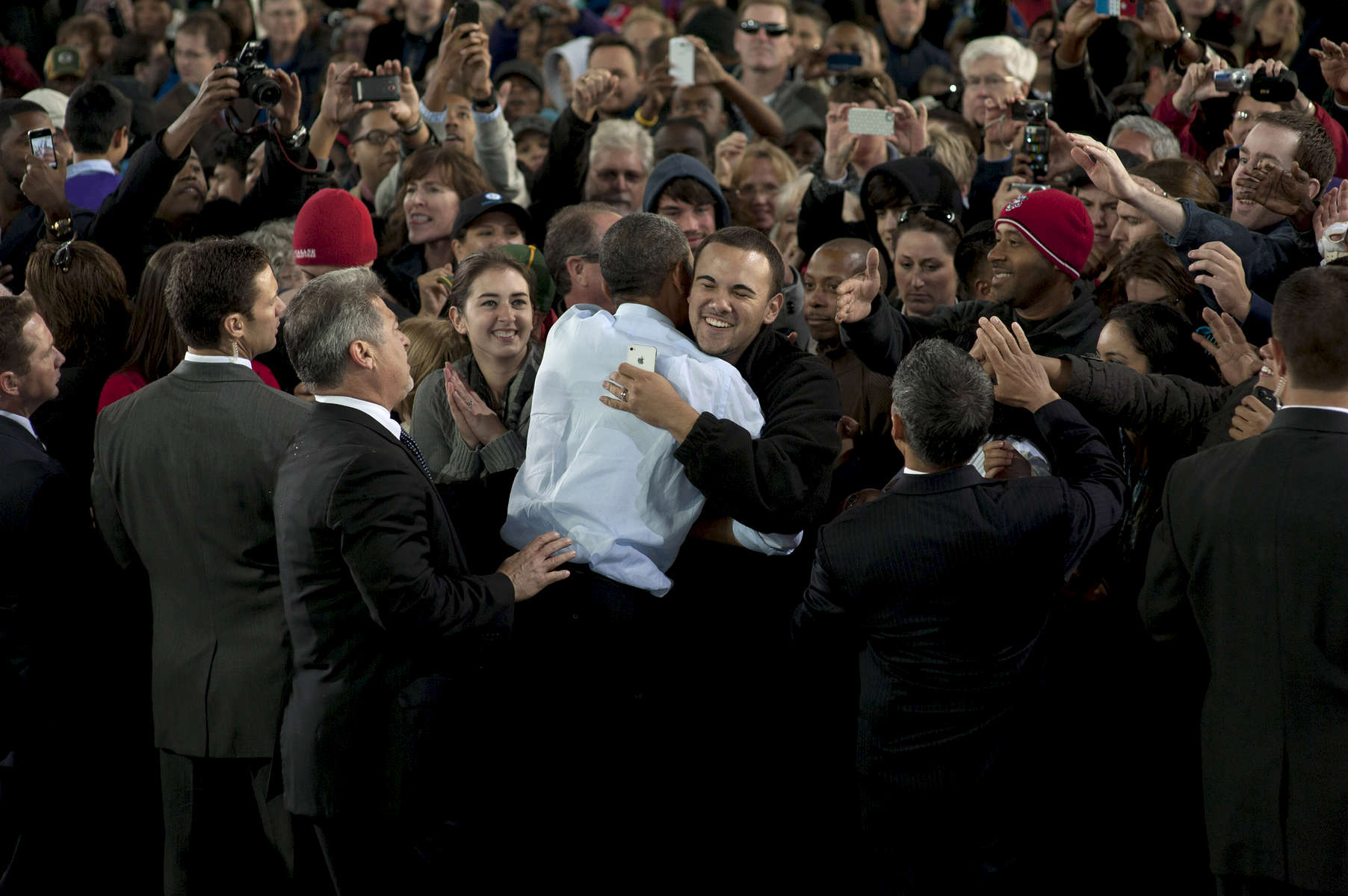 September 22, 2012 - Milwaukee, WI: President Barack Obama embraces a supporter after a rain-soaked campaign event in Milwaukee, WI.  (Scout Tufankjian for Obama for America/Polaris)