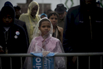 October 5, 2012 - Cleveland, OH- A young supporter listens to President Barack Obama speak during a rain soaked rally in Cleveland, OH.  (Scout Tufankjian for Obama for America/Polaris)