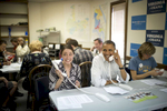 October 14, 2012 - Williamsburg, VA - A young woman reacts as President Barack Obama sits next to her to make phone calls at a campaign field office in Williamsburg, VA.  (Scout Tufankjian for Obama for America/Polaris)