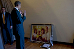 October 23, 2012: Delray Beach, FL:  President Barack Obama reacts as he looks at a painting of his family that a supporter has painted for him. (Scout Tufankjian for Obama for America/Polaris)