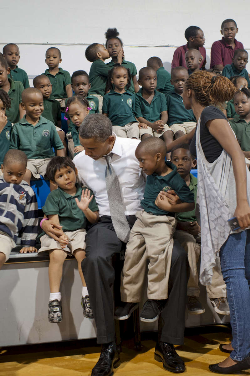 October 23, 2012 - Delray Beach, FL: A young student at the Daughter of Zion Jr. Academy in Delray Beach, FL takes advantage of a picture with President Barack Obama to kiss his classmate. (Scout Tufankjian for Obama for America/Polaris)