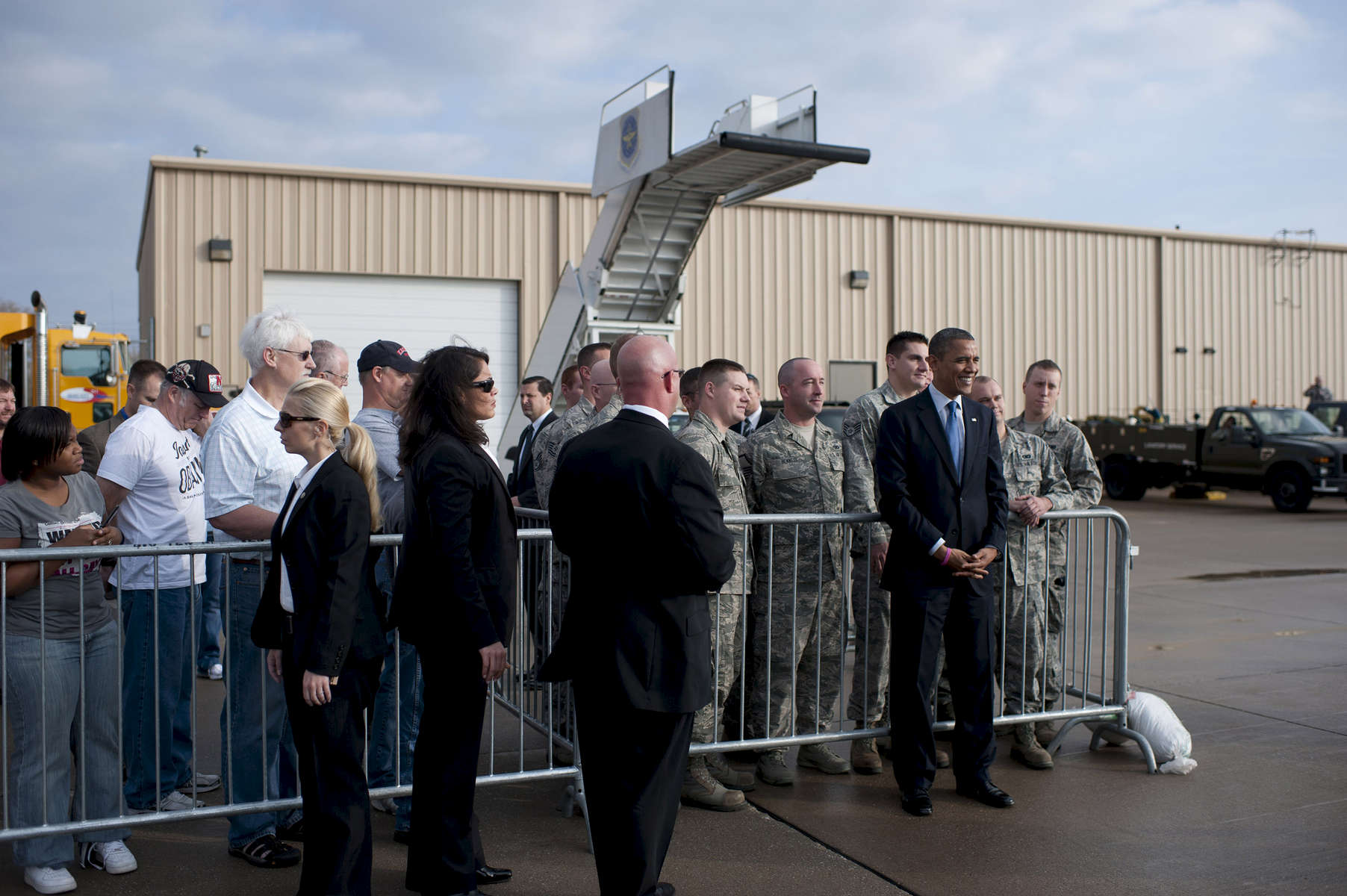 October 24, 2012 - Moline, IL:  President Barack Obama poses for a picture with servicemen at the airport in Moline, IL on his first stop on a whirlwind 48 hours of straight campaigning. (Scout Tufankjian for Obama for America/Polaris)