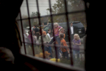 October 27, 2012 - Merrimack, NH:  A mother holds up her daughter so that she can see President Barack Obama through the window of the Common Man Pub in Merrimack, NH.  (Scout Tufankjian for Obama for America/Polaris)