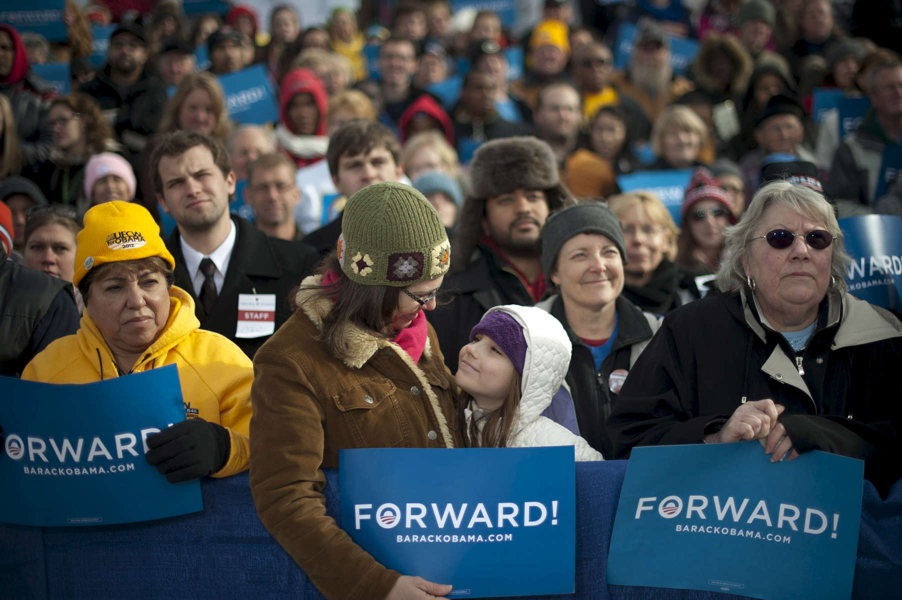 November 1, 2012 - Green Bay, WI: A mother and daughter beam at each other at a tarmac rally for President Barack Obama a few days before the 2012 election.  (Scout Tufankjian for Obama for America/Polaris)