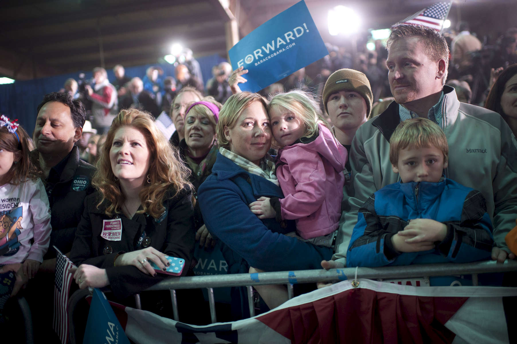 November 2, 2012 - Hilliard, OH: A mother and daughter listen to President Barack Obama speak at a rally in the small town of Hilliard, OH a few days before the 2012 election.  (Scout Tufankjian for Obama for America/Polaris)