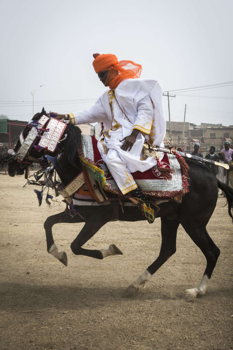 A member of the Emir of Kano, Muhammed Sanusi II, court races his horse outside the palace in Kano, Nigeria
